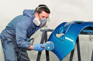Worker Painting Blue Bumper.